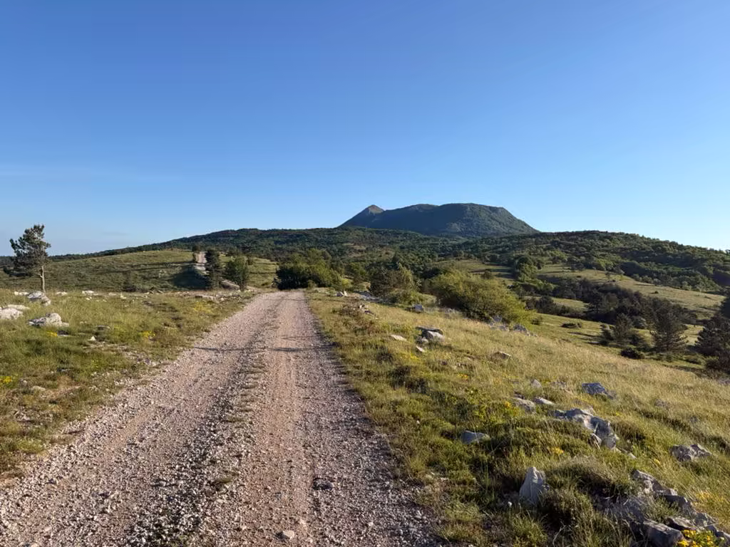 Gravel road leading to Učka summit with mountain in background